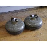 A pair of granite curling stones, each with ebonised wood and brass handle. Diameter 26cm