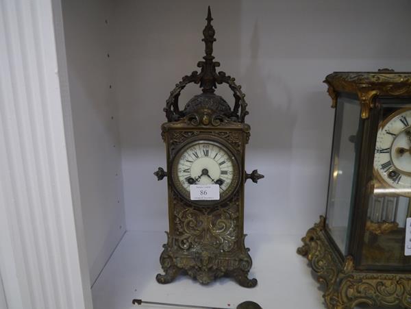 A French 19th century bronze mantel clock, the case elaborately cast with foliate scrolls and