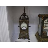 A French 19th century bronze mantel clock, the case elaborately cast with foliate scrolls and