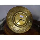 An Art Nouveau brass wall clock, c. 1910,the dial repousse with Roman numerals within a Celtic band,