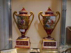 A pair of Vienna Porcelain urns and covers, late 19th century, each painted with the figure of Cupid