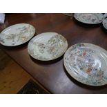 Three Chinese porcelain famille verte shallow dishes, one painted with ladies seated in a garden,