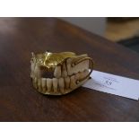 A full set of gold-mounted false teeth, 19th century, the top and bottom sets mounted in gold (