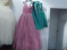 A vintage 1950's pink chiffon with white polka dots evening dress together with a 1980's green