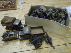 A group of vintage military toy vehicles and a box of German and other toy soldiers