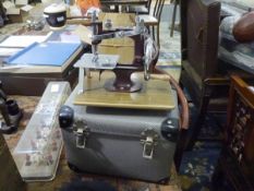 An Essex miniature sewing machine, c. 1960, in its original case