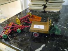 A group of Dinky model vehicles comprising: a Triple Gang Mower no. 323; a Rake no. 324; a Land