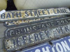 A group of four street signs including Bath Street Lane and Brunswick Road