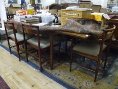 A Mcintosh rosewood extending dining table with six dining chairs including two carvers