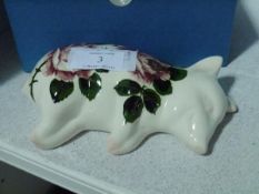 A Griselda Hill Wemyss Pottery sleeping piglet, painted with roses, painted marks, decorated by