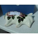 A Griselda Hill Wemyss Pottery sleeping piglet, painted with roses, painted marks, decorated by