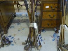A group of fourteen vintage golf clubs, some hickory shafted