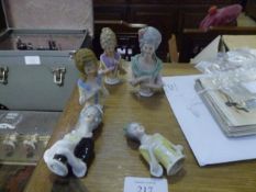 A group of five 1920's porcelain "pin cushion" dolls