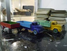 Three Dinky model vehicles comprising: a Leyland Comet Lorry in blue with hinged tailboard no.