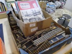 A box of Trains Illustrated magazines, together with a quantity of model rail track