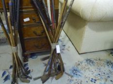 A group of twelve vintage golf clubs, some hickory shafted