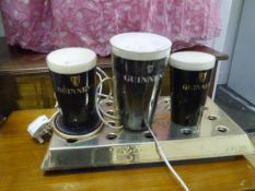 A group of Guinness advertising wares including drip trays