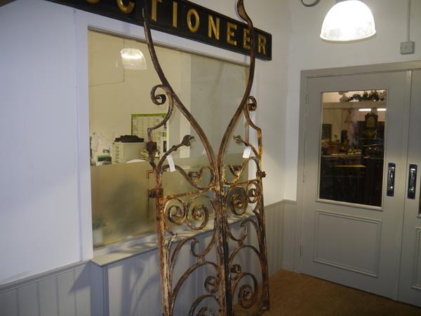 A pair of imposing wrought iron garden gates, c. 1900, in the Art Nouveau taste each with a boldly