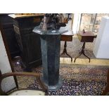 A green marble stand, the octagonal top on a conforming column and stepped base. 92cm by 42cm