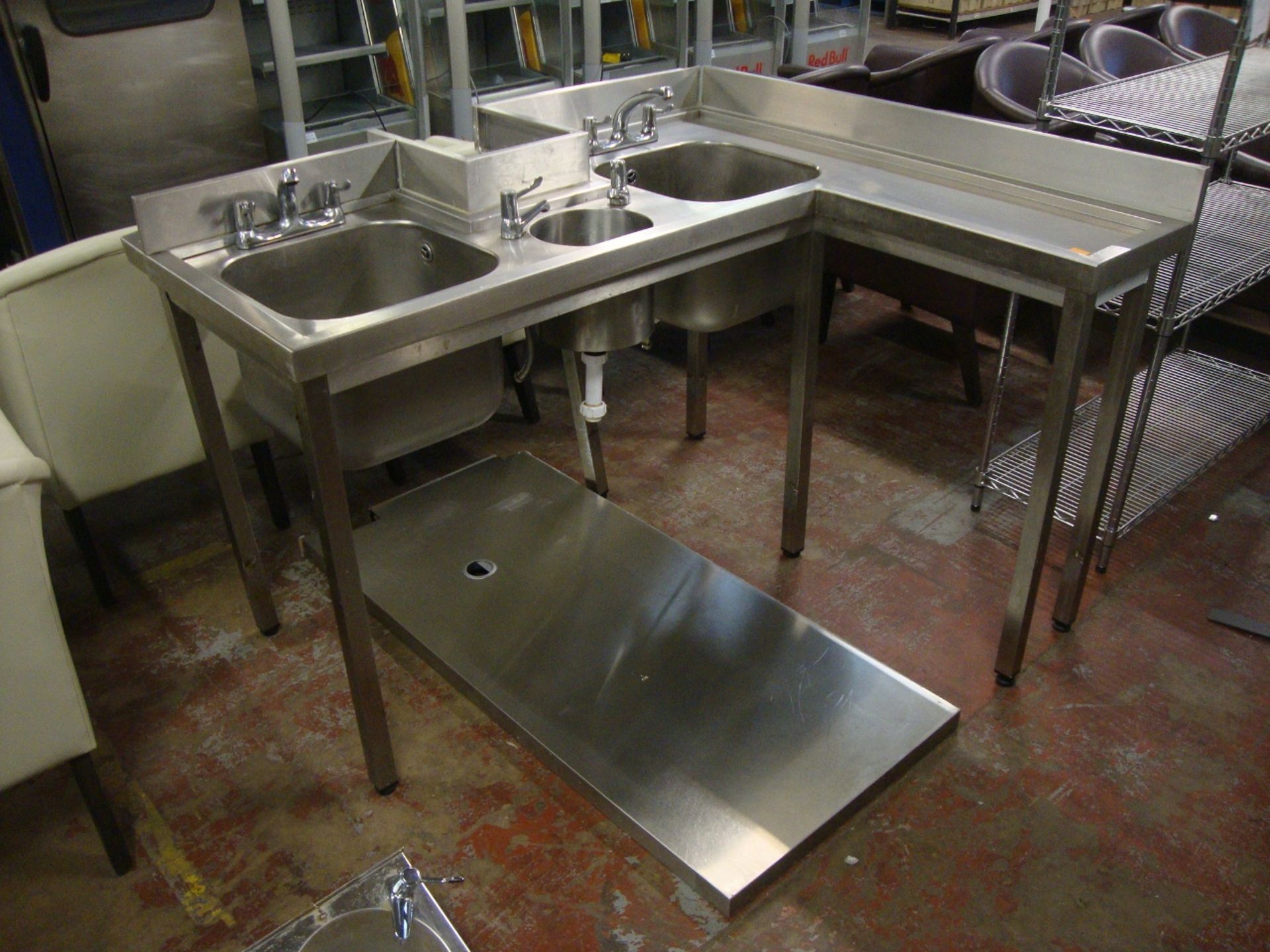 Large stainless steel basin system comprising floor standing L-shaped unit with twin large bowl