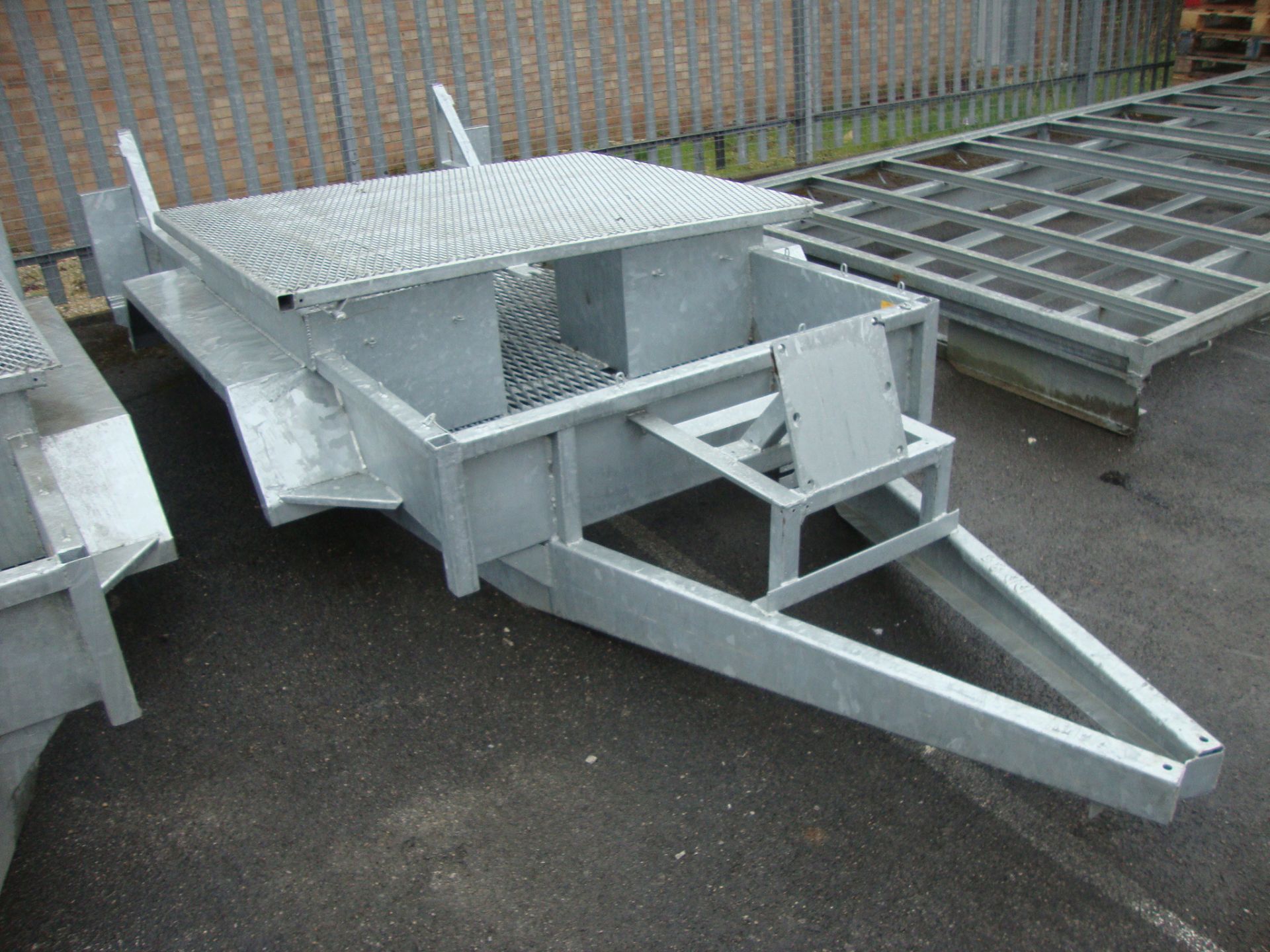 Mini digger/excavator trailer chassis, in galvanised steel, incorporating shrouds for driving the