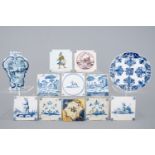 A Dutch Delft blue and white plate, a vase and a collection of tiles, 17/19th C. - The tiles are