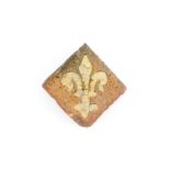 A medieval tile with a Fleur-de-Lys, probably Franco-Flemish, 14th C. - Dim.: ca. 5,5 x 5,5 cm. -