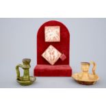 Two medieval tiles and two late medieval candlesticks, 16/17th C. - Dim.: 7,5 x 7,5 cm (tile) H.: 10