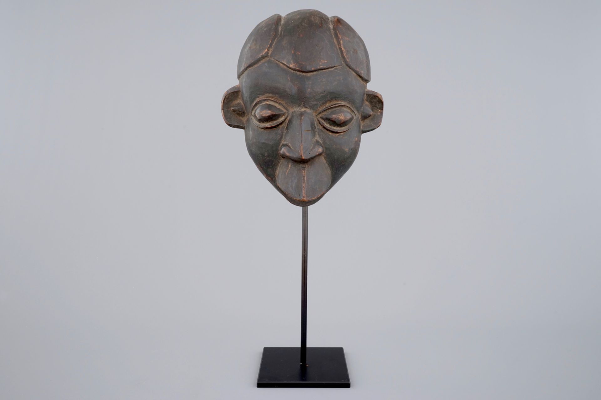 An African carved wooden mask, Bamum, Cameroon H.: 59,5 cm (incl. stand) Condition reports and