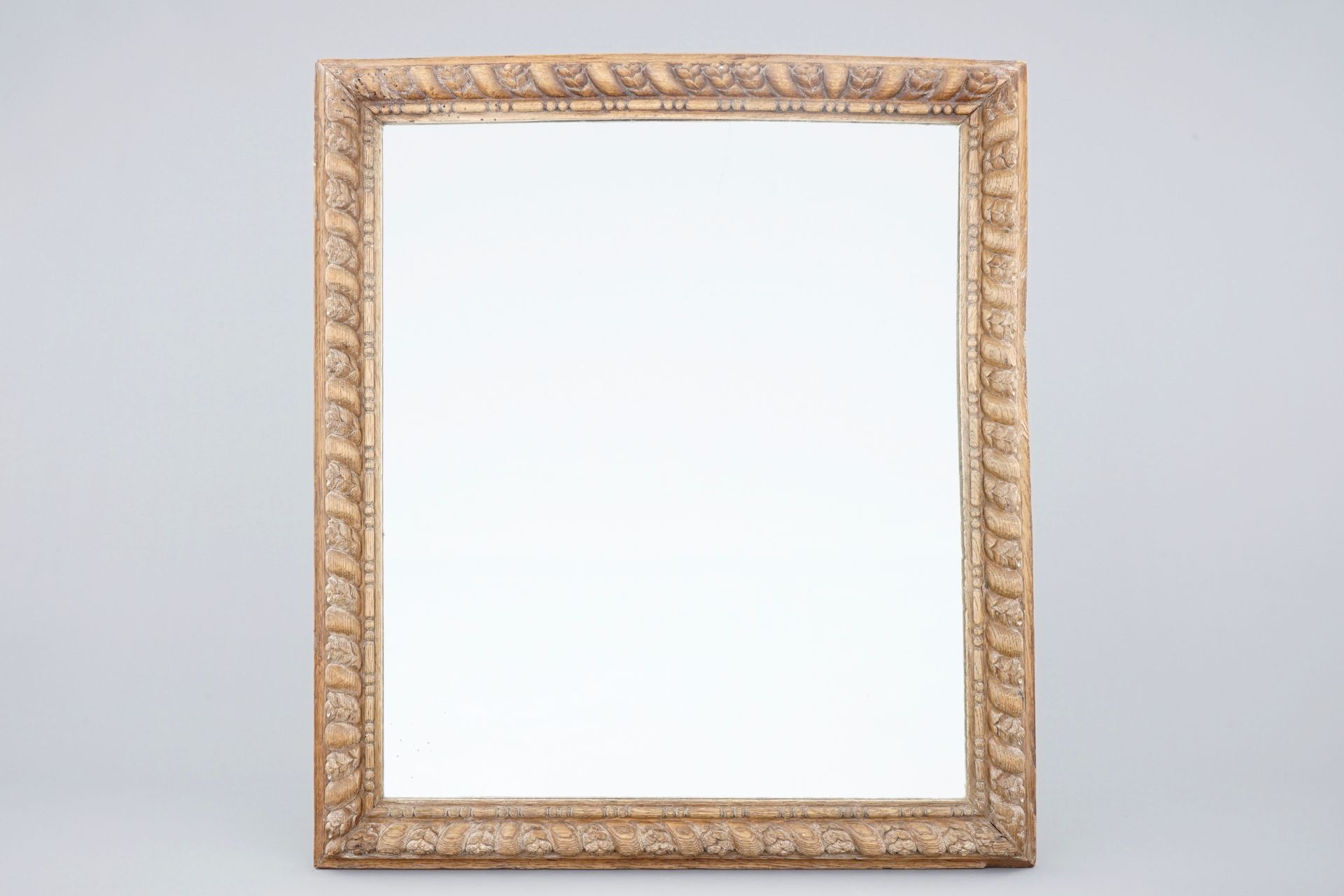 A mirror in carved wood frame, 18/19th C.