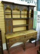 An early 20th Century Flemish style oak dresser, the open back Delft rack with stepped cornice