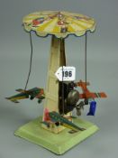 A vintage Continental chairoplane carousel, delightful clockwork toy with dinging bell action, three