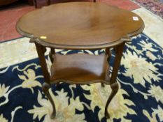 An Edwardian mahogany shaped top two tier side table on slender pad foot legs, 73 cms, 61.5 cms