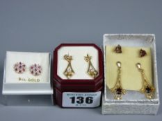 A pair of diamond and ruby cluster stud earrings with twelve tiny diamonds and seven rubies each,