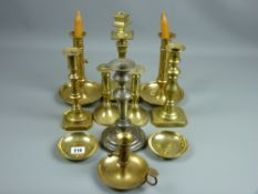 A large parcel of mixed brass chambersticks and candlesticks
