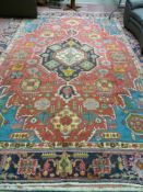 A red ground Persian Tabriz multi-coloured carpet with medallion design, 390 x 278 cms
