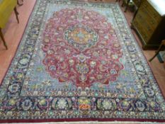 A 20th Century Persian rug, large and highly decorative with loabed edge central pattern, bird and