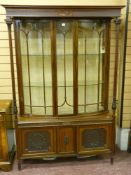 A good early 20th Century mahogany display cabinet, stepped cornice above a reeded pattern frieze