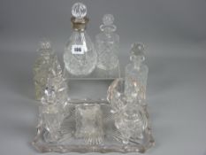 A silver banded cut glass scent bottle with associated stopper, three further dressing table scent