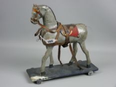 An early 20th Century, probably German carved wood and painted composition pull-along horse, 30 x 30