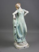 A large Berlin porcelain figure of a young woman, classically styled in a flowing dress held up with