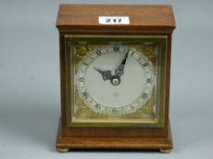 An Elliott mahogany cased mantel clock, silvered dial with Roman numerals, winged cherub gilt