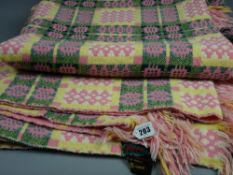 A vintage pink and yellow Welsh woollen blanket, original label attached stating a 'Derw Product,