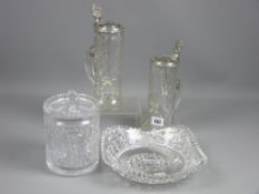 A pair of cut glass lidded steins with pewter metal mounts and facet cut lids with etched names, a