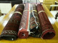 Four 20th Century Iranian red ground patterned rugs, various sizes