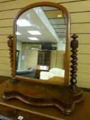 A Victorian mahogany swing toilet mirror with barley twist support columns on a shaped base with