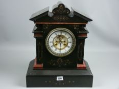 A 19th Century architectural style black slate and red marble mantel clock, the floral chased