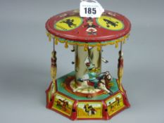 A vintage tinplate clockwork merry-go-round with children riding animals, colourful lithograph