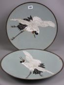 A pair of Japanese cloisonne chargers depicting adult red crowned Cranes of a grey background, 37
