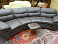 A modern brown leather effect crescent shaped four seater settee with an associated footstool, 306